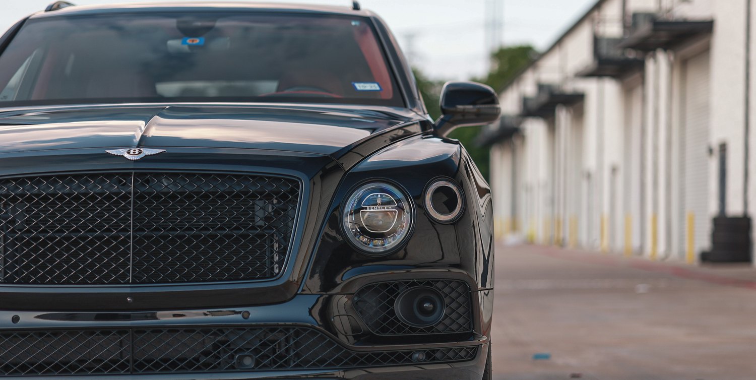 Grille and headlight of a ceramic coated black Bentley Bentayga Speed