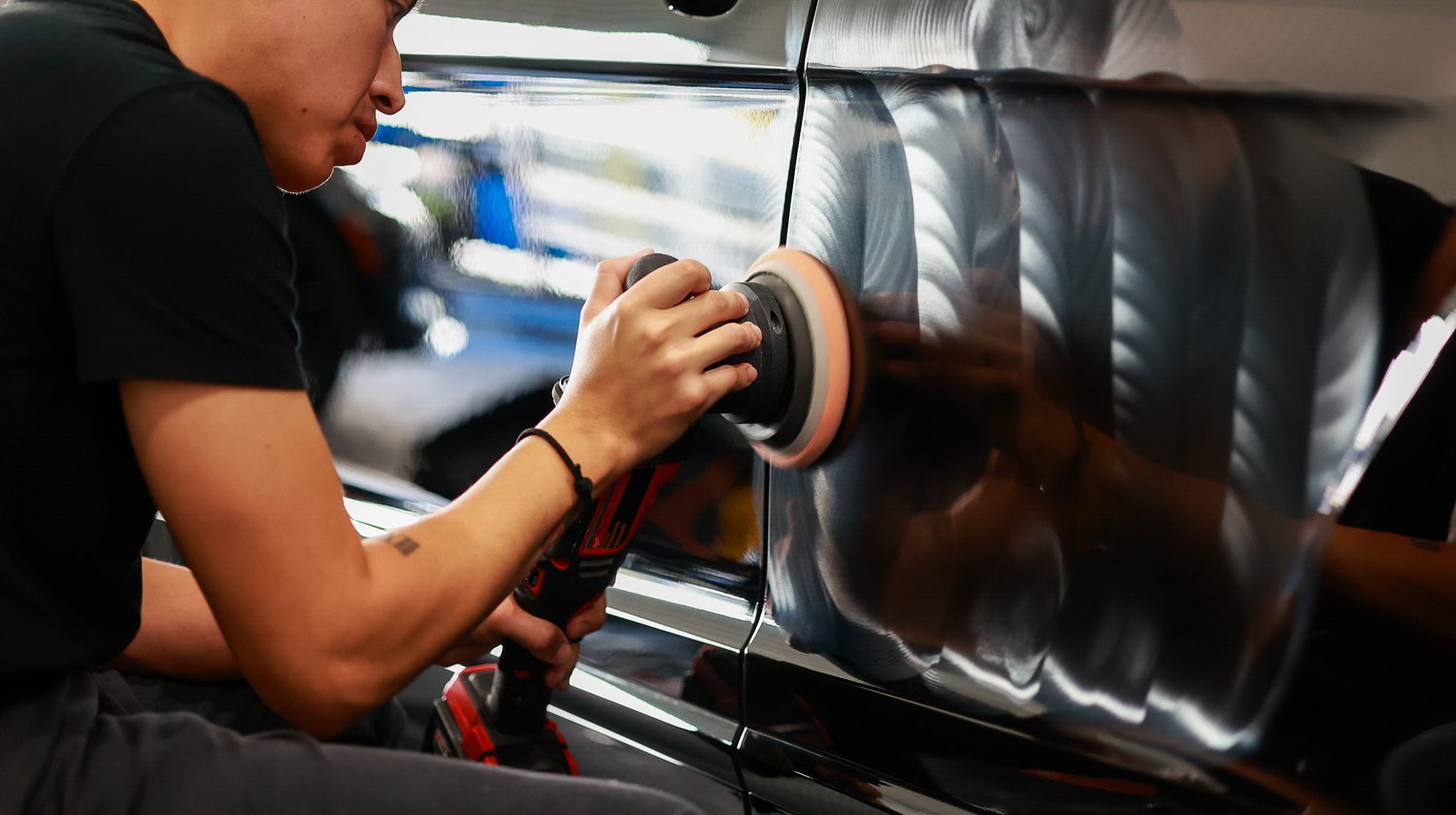 Reflections in the corrected rear quarter panel of a Bentley Bentayga