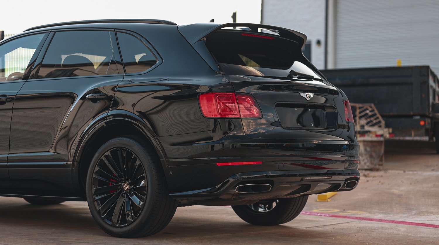 Rear three quarter view of a black Bentley Bentayga Speed