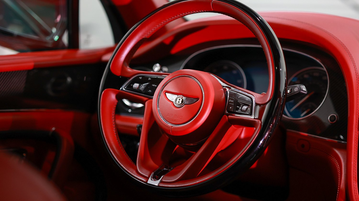 Red interior and steering wheel of a Bentley Bentayga Speed