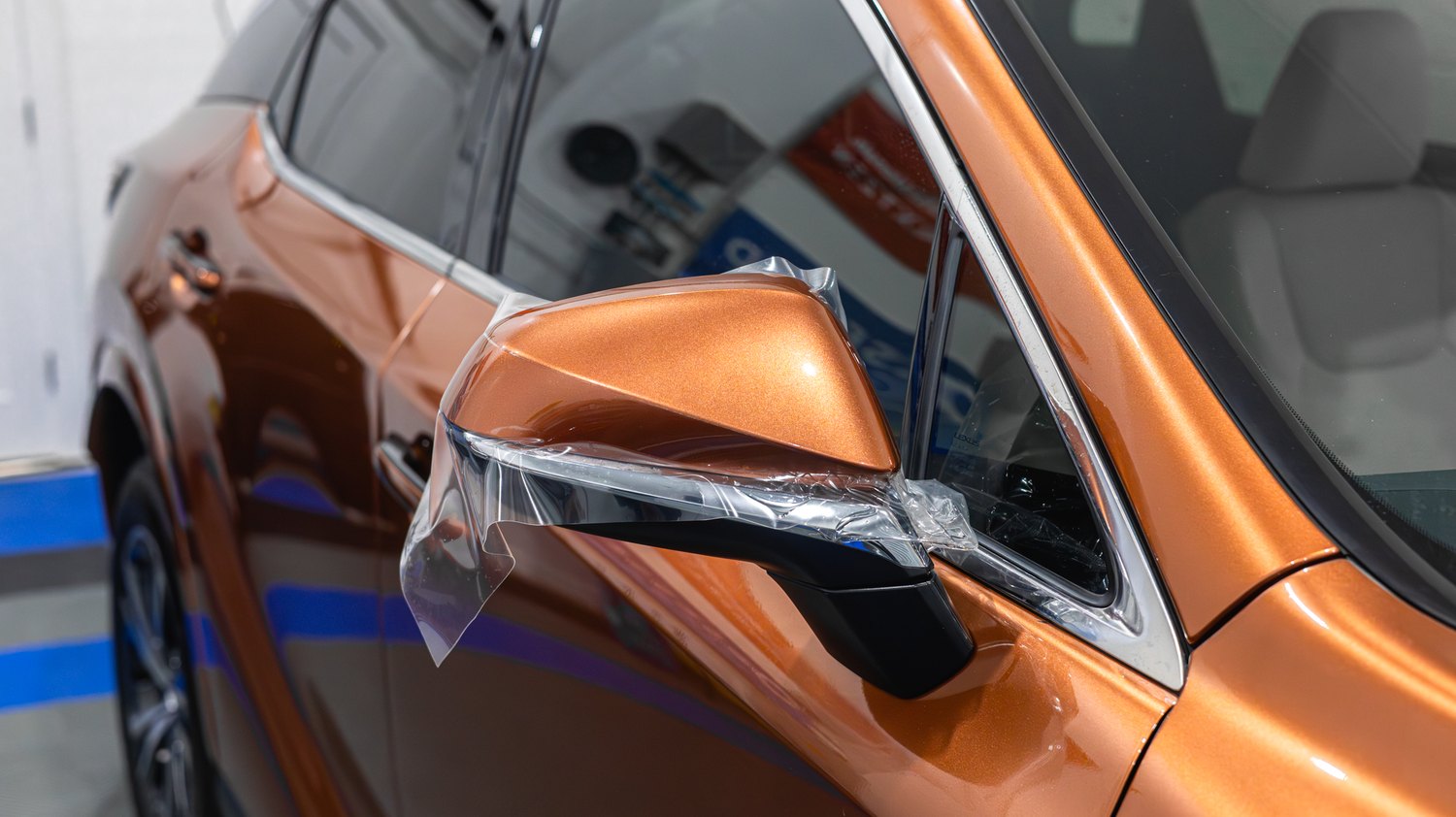 Paint protection film wrapped around the mirror cap of a Lexus RX 350
