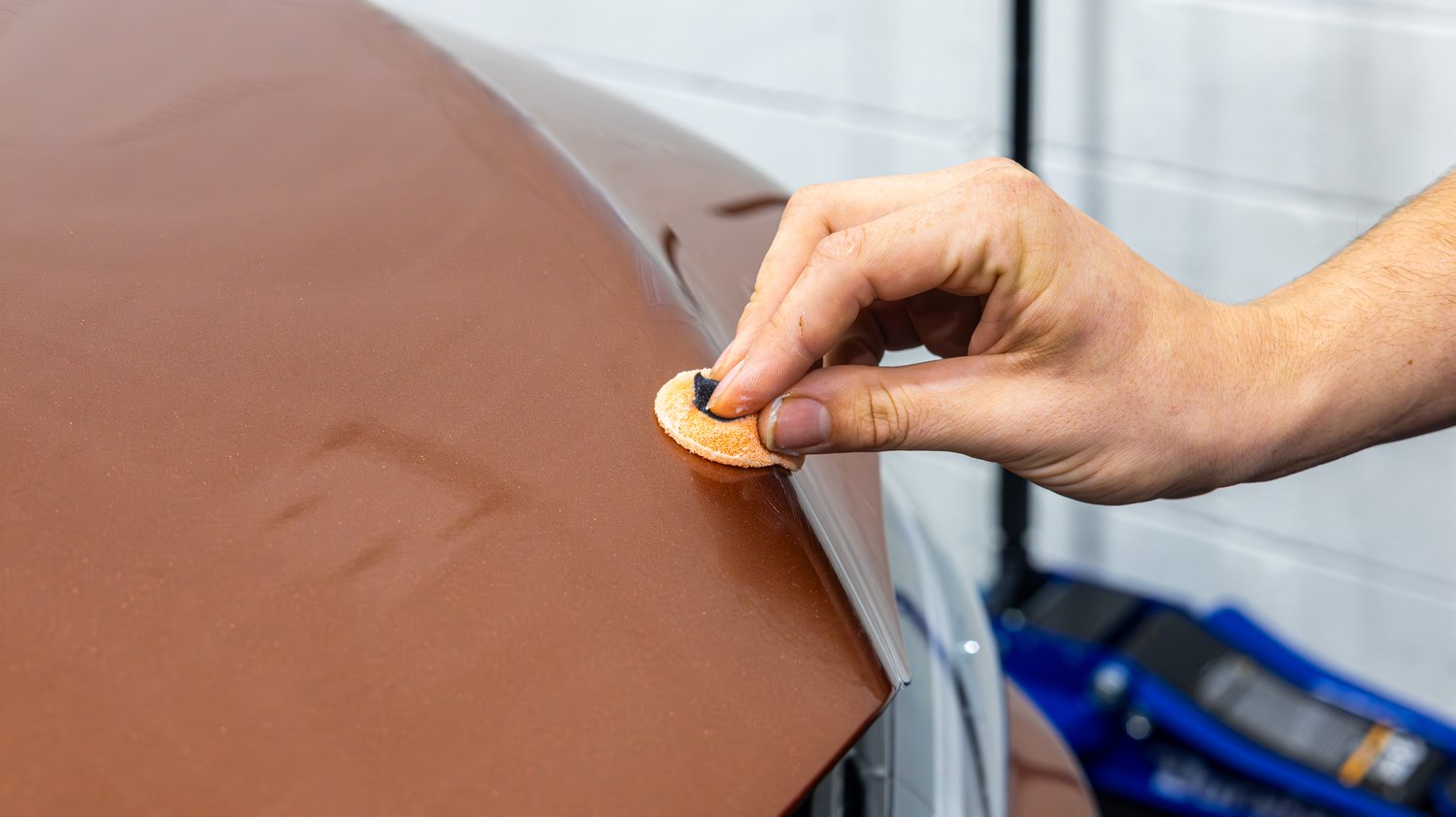 Preparing the hood edge of a copper Lexus RX 350 before PPF