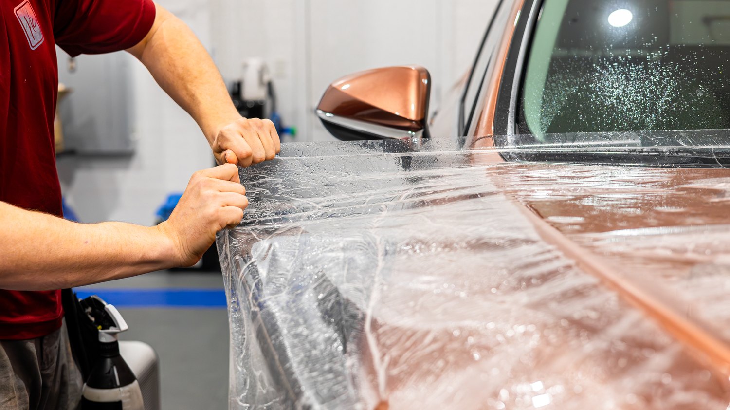 Stretching paint protection film over the front fender of a Lexus RX 350