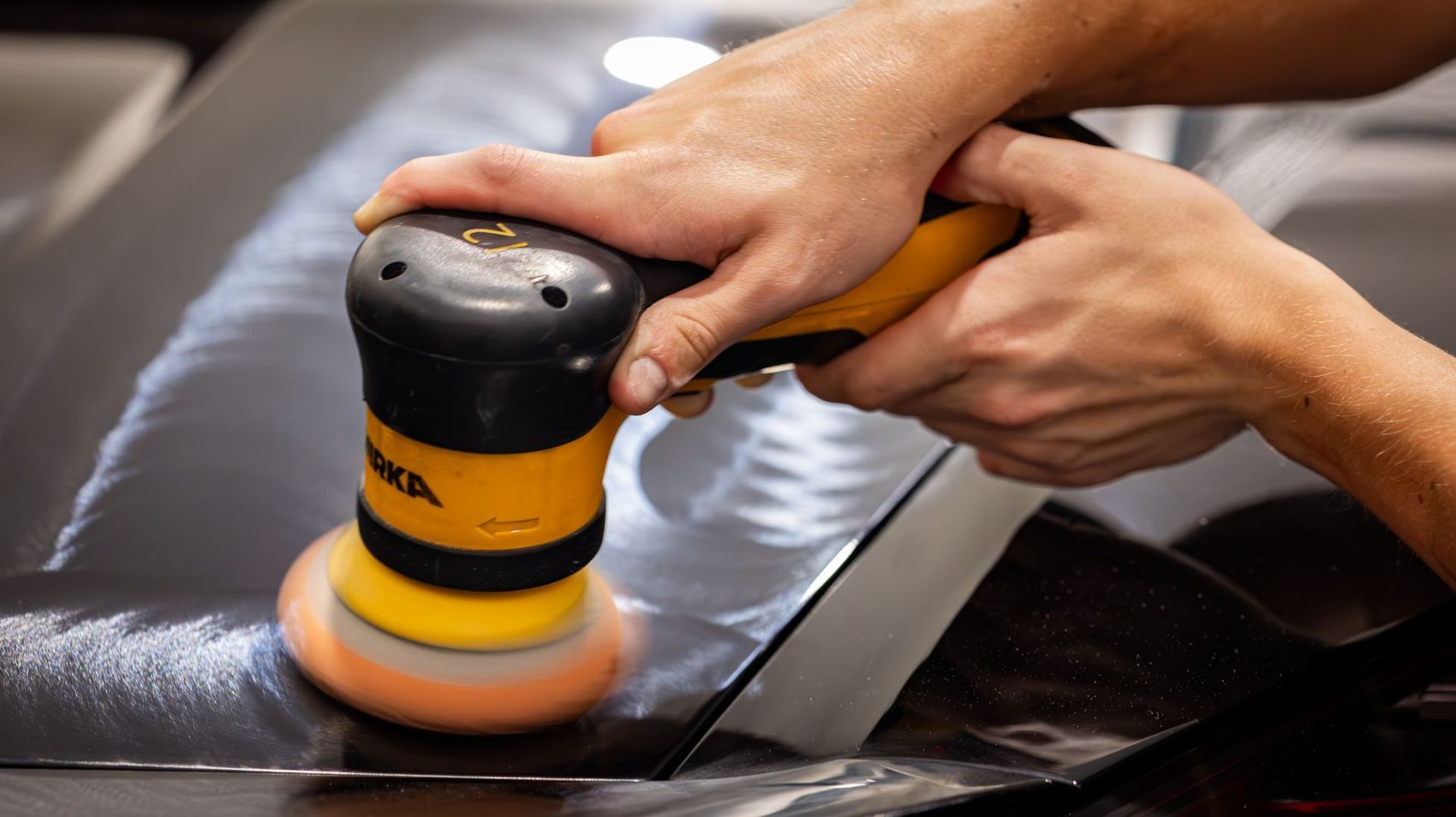 Machine polishing paint in the Humble Crew shop in Plano