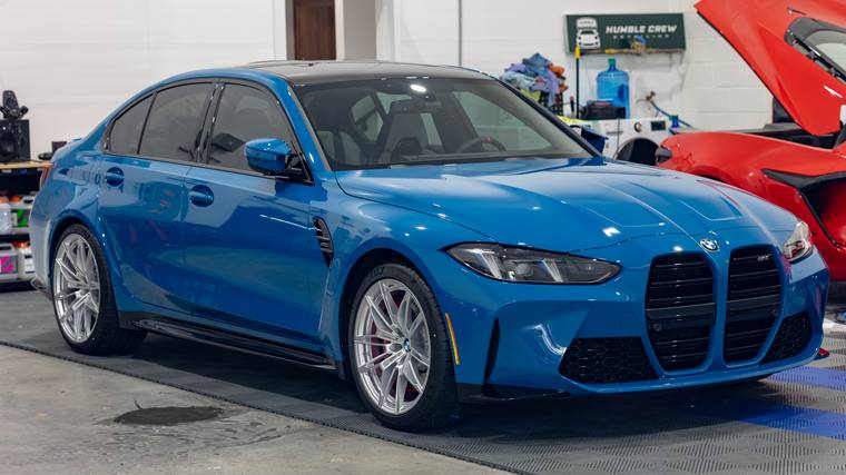 Laguna Seca Blue BMW M3 G80 paint protection film, ceramic coating — front three quarter in shop at Humble Crew Auto Spa, Plano TX