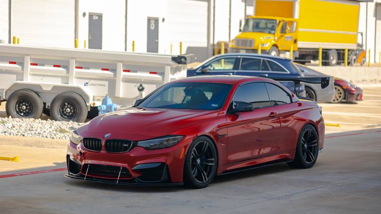 Orange BMW M4 F82 Track Package paint protection film, ceramic coating — wheels off front three quarter at Humble Crew Auto Spa, Plano TX