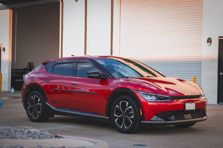 Red Kia EV6 Wind paint protection film, ceramic coating — front three quarter at Humble Crew Auto Spa, Plano TX
