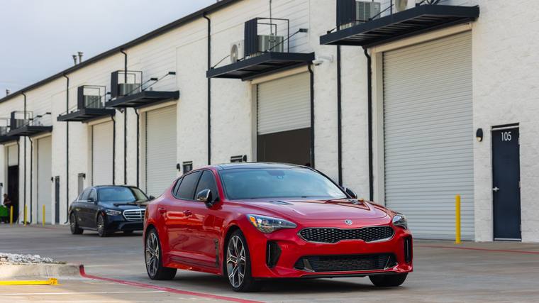 Red Kia Stinger GT2 ceramic coating, paint correction — front three quarter at Humble Crew Auto Spa, Plano TX