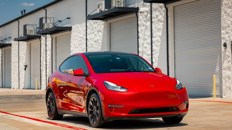 Red Tesla Model Y Long Range paint protection film, ceramic coating — front three quarter at Humble Crew Auto Spa, Plano TX