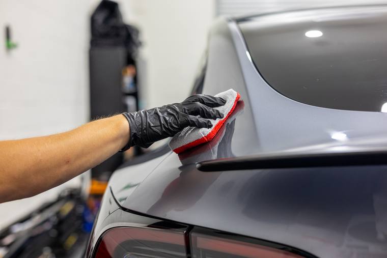 Silver Tesla Model Y Juniper ceramic coating — application rear spoiler at Humble Crew Auto Spa, Plano TX