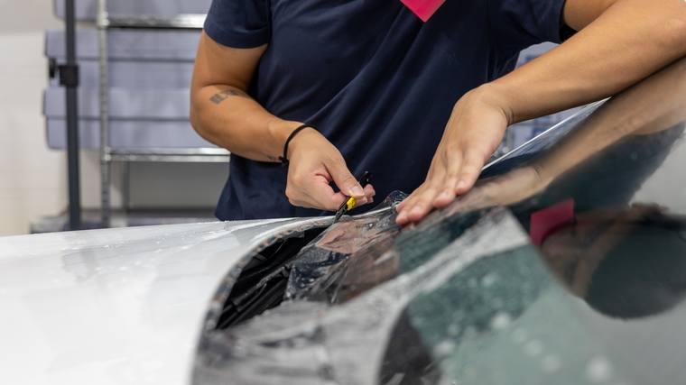 White Tesla Model Y Juniper paint protection film — windshield edge at Humble Crew Auto Spa, Plano TX