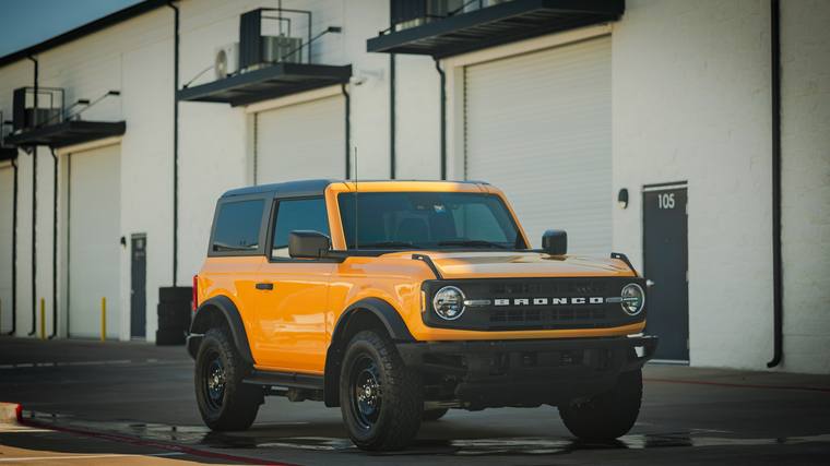 Yellow Ford Bronco Big Bend Two-Door paint protection film, ceramic coating — front three quarter at Humble Crew Auto Spa, Plano TX