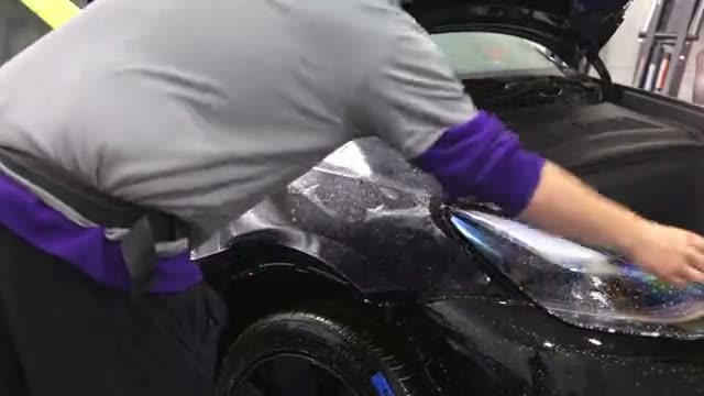Paint protection film going onto a car at Humble Crew Auto Spa in Plano, TX
