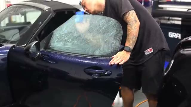 Window tint being installed at Humble Crew Auto Spa in Plano, TX