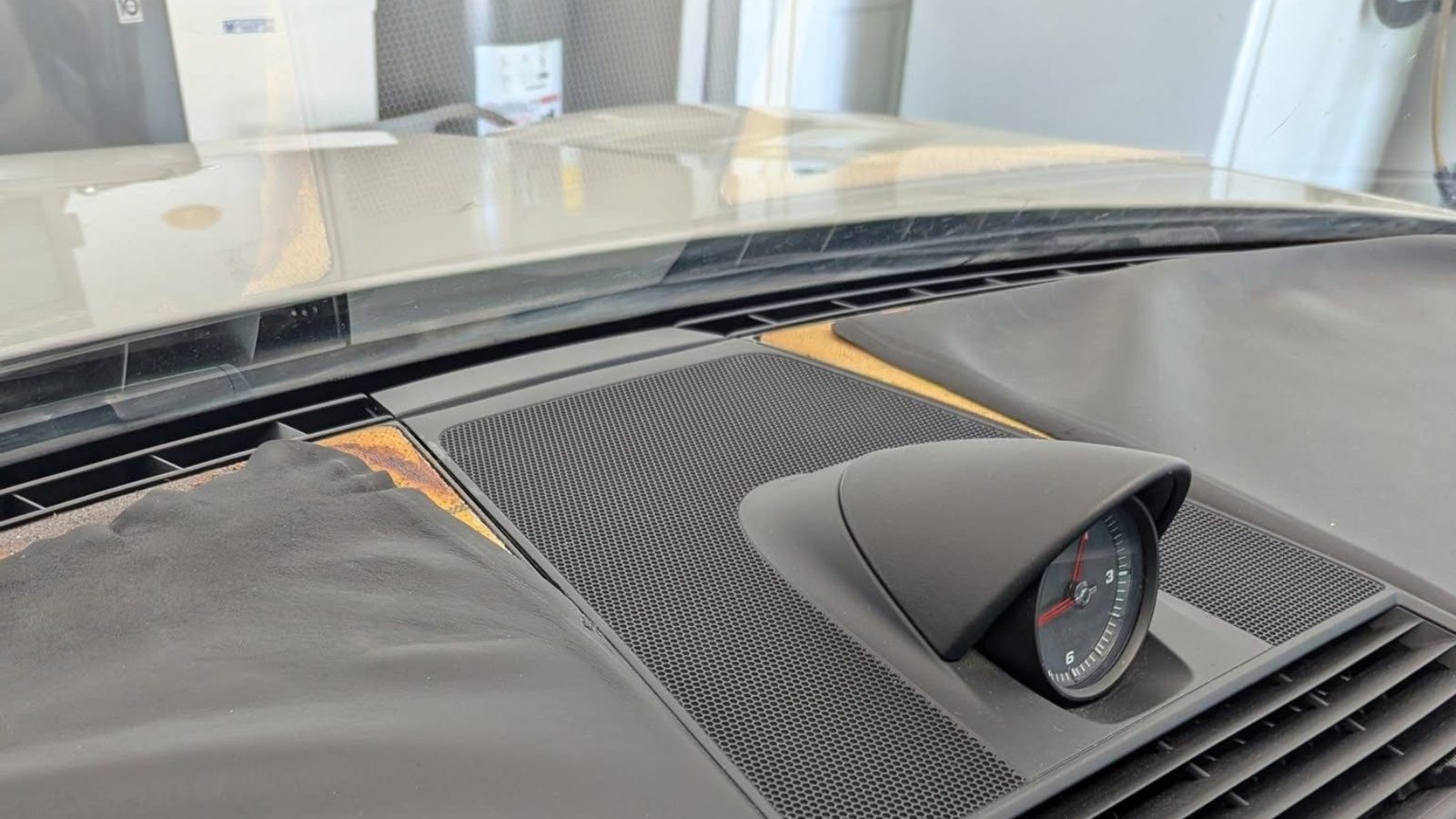 Sunlight across a car dashboard behind tinted glass