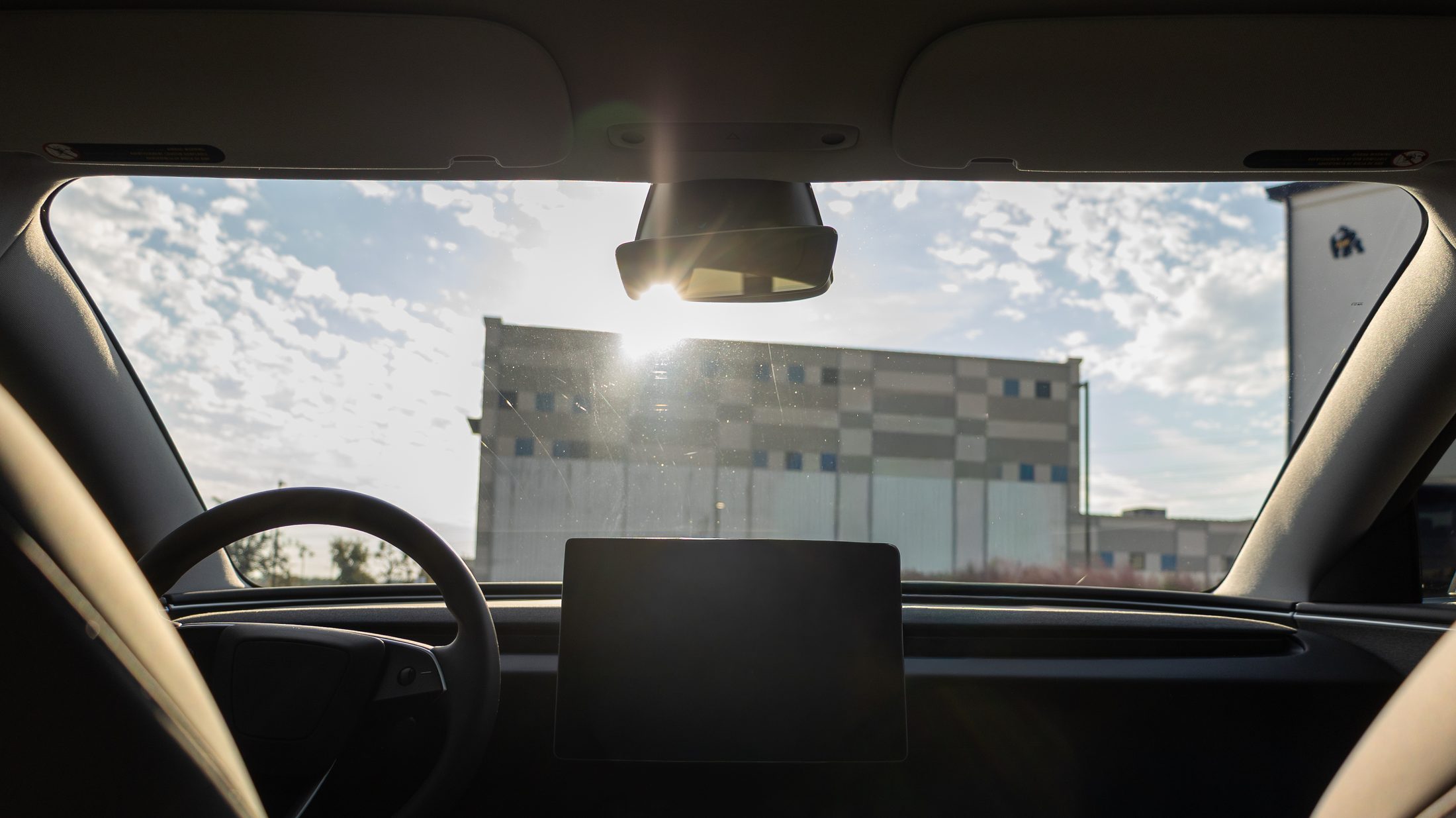 The same windshield with ceramic tint — the sky and clouds are visible and the glare is gone
